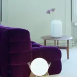 Purple lounge chair with sculptural lighting in the Salon Vert concept