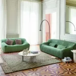 Green sofas and patterned parquet in the Salon Vert concept