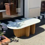 Antibes coffee table with a marble top in the sun outside the Belle & George shop