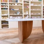 Antibes dining table with green marble top, three-quarter view