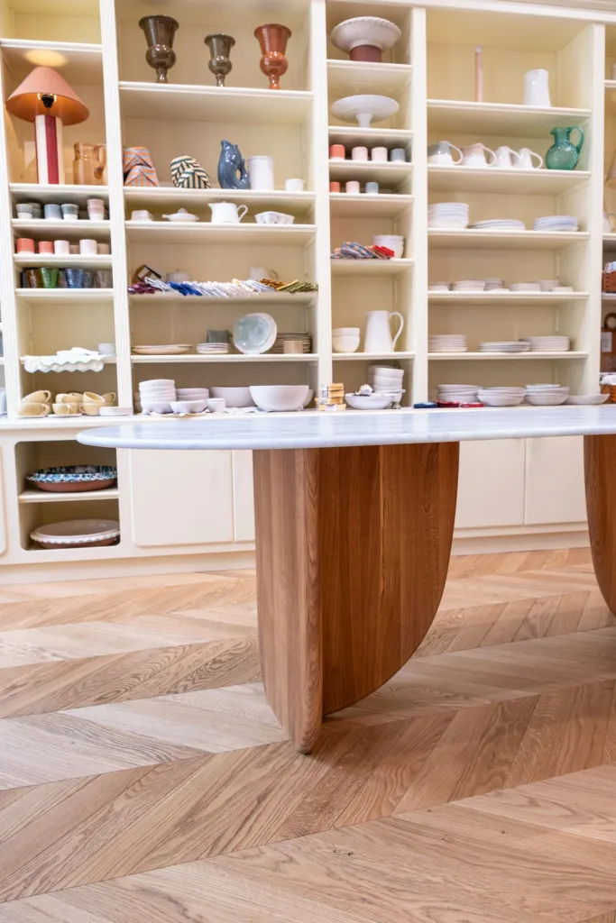 Antibes dining table with green marble top, three-quarter view