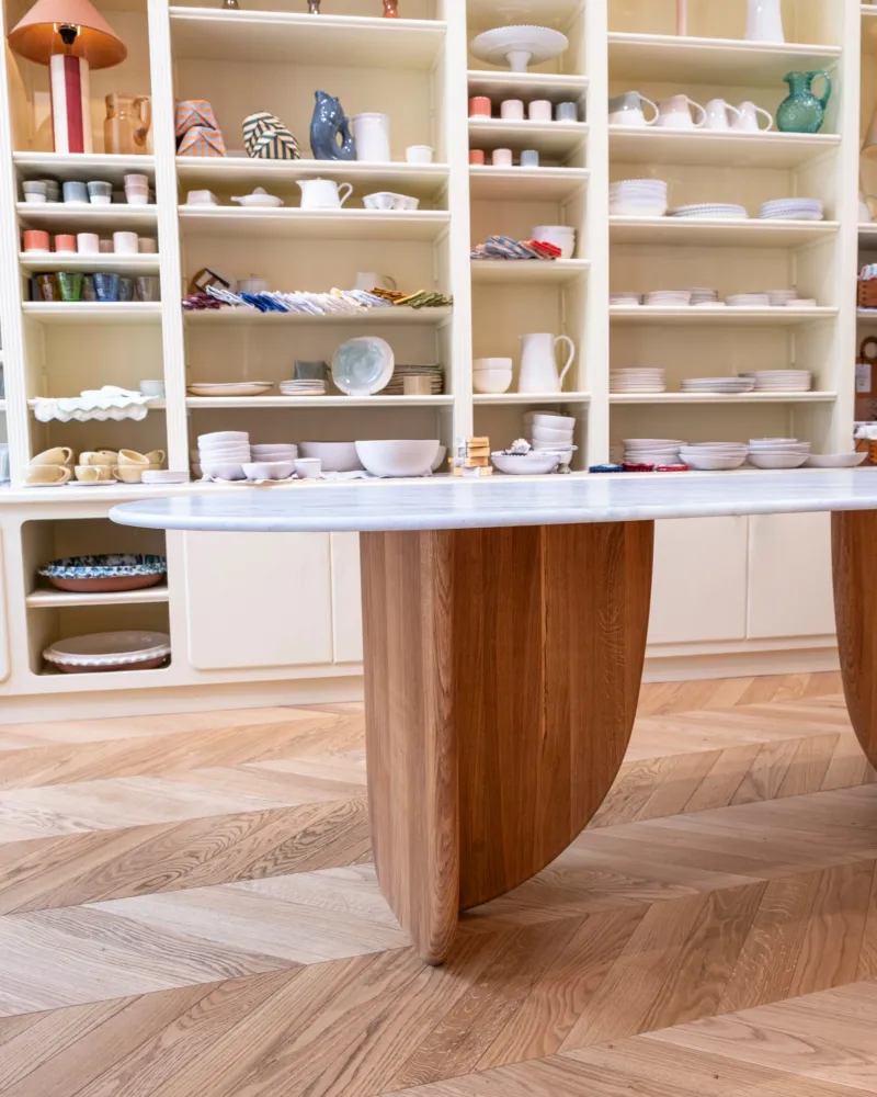 Antibes dining table with green marble top, three-quarter view