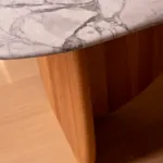 White marble edge and wood support of the Antibes dining table