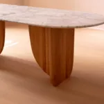 White marble top and wood support of the Antibes dining table