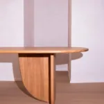 Curved wood supports of the Antibes dining table