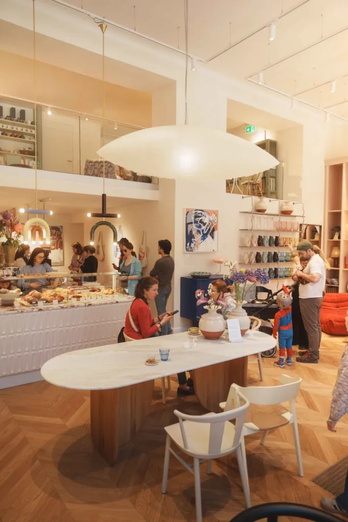 Guests gathering around the Parémi café counter inside Belle & George